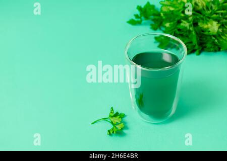 Monochrome green picture with chlorophyll water in a glass on green background with space for text Stock Photo