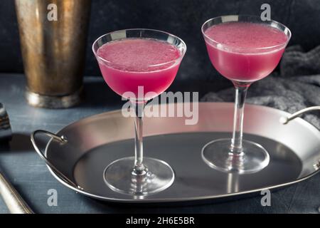 Cold Refreshing Purple Aviation Cocktail with a Cherry Garnish Stock Photo