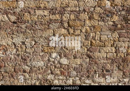 Stone wall as a background or texture. Part of a stone wall, for background or texture, brick wall. Stock Photo