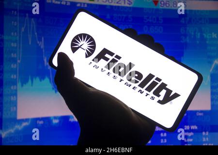 Brazil. 14th Nov, 2021. In this photo illustration the Fidelity Investments logo displayed on a smartphone screen and a stock market graph in the background. (Photo by Rafael Henrique/SOPA Images/Sipa USA) Credit: Sipa USA/Alamy Live News Stock Photo