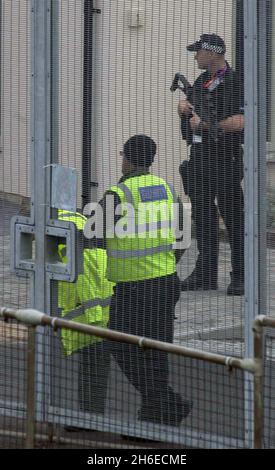As athletes begin to arrive in the UK, armed police are seen guarding the Olympic Village in Portland, Dorset this afternoon. Stock Photo