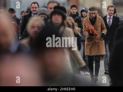 Commuters wrap up as they make their way to work in the freezing weather on the Millennium Bridge in central London this morning.     Stock Photo