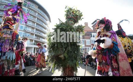 The Twelfth Night annual seasonal celebration took place in the Bankside area of London. January 6th is Epiphany and Twelfth Night which is the traditional end of the Christmas festive season and a celebration of the New Year. To herald the celebration the Holly Man, in the Winter guise of the Green Man from pagan myths and folklore, decked in evergreen foliage, arrived at the Globe Theatre from the River Thames on the Thames Cutter, Master Shipbroker. Stock Photo