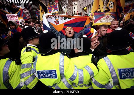 Tibetan protestors are held back by police after the Olympic torch passed by the British Museum in central London today. Stock Photo