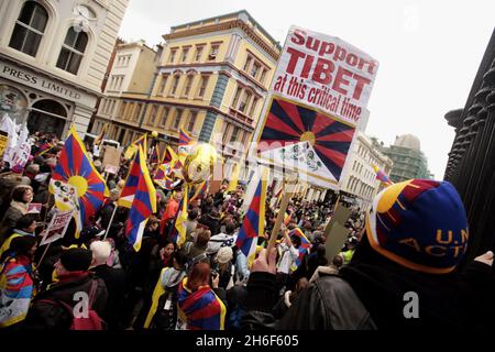 Tibetan protestors are held back by police after the Olympic torch passed by the British Museum in central London. Stock Photo