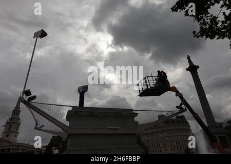 The first person to step on to Trafalgar Square's fourth plinth this morning to start artist Antony Gormley 'living sculpture' project was not the one Gormley had invited, but a banner-wielding protester Anti-smoking campaigner Stuart Holmes was the first unoffical person to stand on the plinth in Trafalgar Square this morning after he managed to climb the netting around the plinth. Antony Gormley's One & Other sculpture involves a different person being on the plinth for an hour each, 24 hours a day for 100 days between 6 July and 14 October. Stock Photo