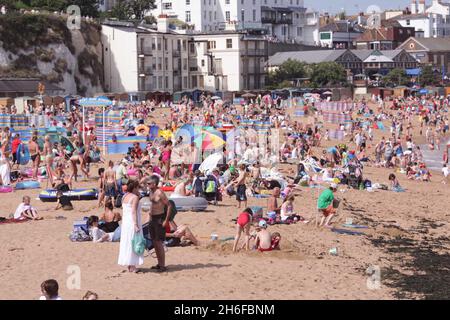Hundreds of thousands of Britons are abandoning foreign holidays in favour of 'staycations' creating a boost to the domestic travel market . The number of Britons travelling abroad fell 10 percent in the year to June 2009 compared with the 12 months to June 2008, the Office for National Statistics said, as sinking sterling made foreign trips more expensive for cash-strapped Britons. There is also good news for holiday makers this week as the met office predicts fine weather again with temperatures topping 28c in the South on Wednesday. Picture shows: Holiday makers enjoying the sun in Broadsta Stock Photo