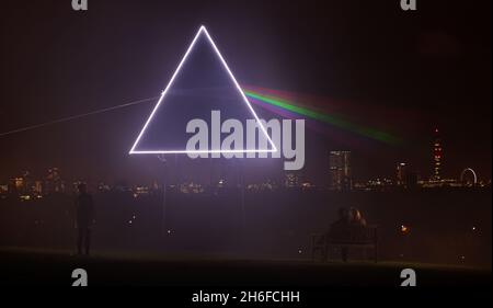 As the sun set over Primrose Hill last night a new addition to the spectacular view of the London skyline came to life. Sky Arts paid tribute to Pink Floyd's iconic Dark Side Of The Moon album cover to coincide with the screening of the band's 1994 live performance of the album, on Sky Arts 1 HD and Sky Arts 1 this Friday. Created using a pyramid structure, LED lighting and powerful light lasers, the spectrum beamed out across the night sky, bringing to life one of the most famous album covers in history. Stock Photo