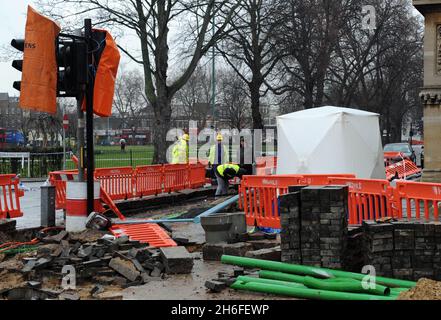 A one-year-old child suffered critical injuries when a lamppost fell in a west London street. Police said they found the baby, thought to be a boy, and a woman, 62, outside Chiswick Town Hall at 10.30 this morning. The incident occurred near the junction of Sutton Court Road and Heathfield Terrace. The baby, who suffered life-threatening injuries, was taken to a central London hospital by air ambulance. The woman remains in a local hospital. Picture shows: The fallen lamp post Stock Photo