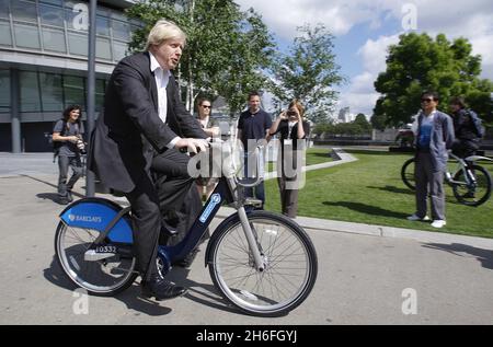 Mayor of London Boris Johnson rides a Barclays Cycle Hire bike at a photocall at Potters Field Park, in central London, where Barclays was announced as the official sponsor of London's new cycle hire scheme, which launches in July. Stock Photo