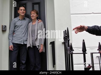 David Miliband poses with his wife Louise Shackleton outside their North London home this afternoon. The shadow foreign secretary will decide his future in UK politics later today after being narrowly beaten by his brother Ed for the Labour leadership Stock Photo