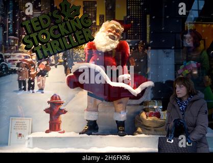 A saucy Santa forms part of a Ted Baker window display in London. The scene includes a moving Father Christmas who lifts his tunic to reveal stockings and suspenders. A similar display in the Cambridge branch of Ted Baker has already received complaints. With one customer branded it as 'sick'. Stock Photo