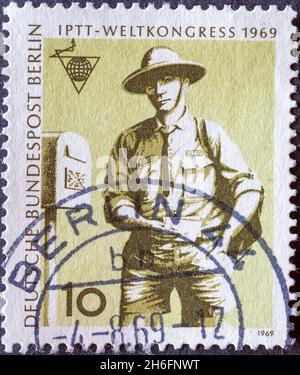 GERMANY, Berlin - CIRCA 1969: a postage stamp from Germany, Berlin showing a picture of the world congress of the postal union: Postman in Australia Stock Photo