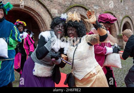 ENSCHEDE, THE NETHERLANDS - NOV 13, 2021: Two female 'black pete's'. Black Pete is the helping hand of the Dutch Sinterklaas. Stock Photo