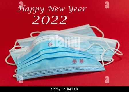 Mouth-nose masks and the text "Happy New Year 2022" Stock Photo