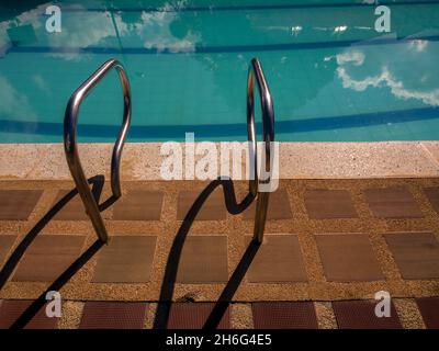 The rails of a swimming pool ladder project their shadow in the morning, in a country house near the town of Chinavita, in central Colombia. Stock Photo