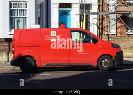 Royal Mail postman delivering mail, London England United Kingdom UK Stock Photo