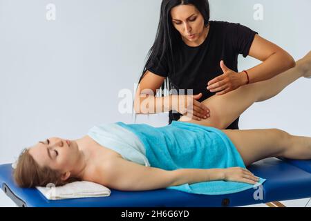 Anti-cellulite massage of hips. lymph drainage treatment. Woman receiving professional body, leg and foot massage. Wellness, healing and relaxation Stock Photo
