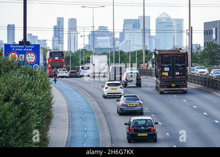 Traffic on A13 Alfreds Way road near Barking with Canary Wharf in the background, London, England, United Kingdom, UK Stock Photo