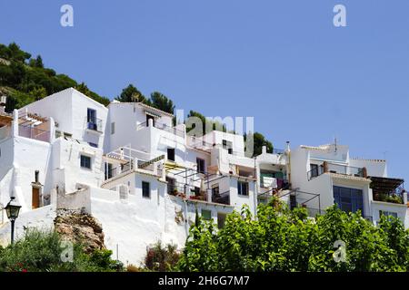 Beautiful Frigiliana village, Spain  Whitewashed traditional houses on a steep hillside  Dramatic landscape with view of the old town Blue sky and cop Stock Photo