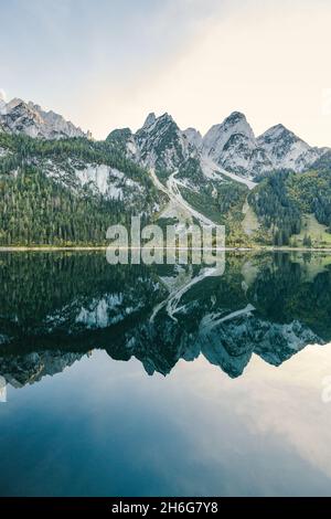 Beautiful view of idyllic colorful autumn scenery with Dachstein mountain summit reflecting in crystal clear Gosausee mountain lake in fall Stock Photo