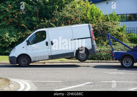 A wheel-lift tow truck with broken van in London England United Kingdom UK Stock Photo