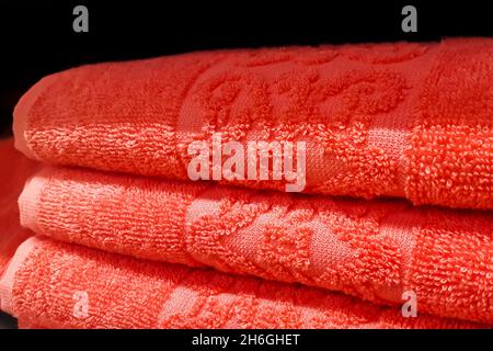 Stack of bath towels. Home textiles for spa treatments. Soft fluffy fabric texture. Stock Photo