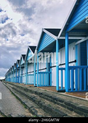 A row of beautiful blue beach huts at the traditional British seaside town of Bridlington Stock Photo