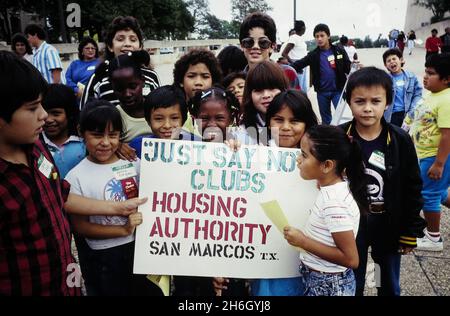 San Marcos Texas USA, circa 1992: Children participate in anti-drug club's 'Just Say No' campaign meeting at low-income housing project. ©Bob Daemmrich Stock Photo