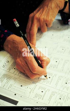 San Antonio Texas USA, 1990: Elderly Hispanic woman filling out the 1990 United States Census short forms. ©Bob Daemmrich Stock Photo