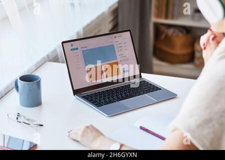 Close up of unrecognizable woman using laptop with e-education website at home, copy space Stock Photo