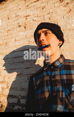 Portrait of a trendy Caucasian male teenager posing outdoors Stock Photo
