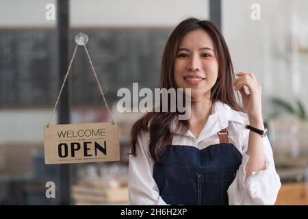 Portrait of Startup successful small business owner in coffee shop.handsome woman barista cafe owner. SME entrepreneur seller business concept Stock Photo