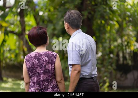 Middle aged couple relaxing in backyard. Stock Photo