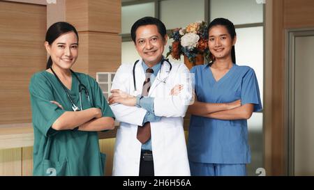 Group of modern doctors smiling standing as a team with arms crossed in hospital, Health care, insurance and help medical staff concept Stock Photo