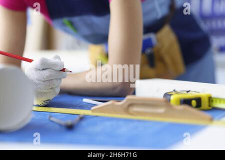 Woman worker making corrections in construction planning with pencil Stock Photo