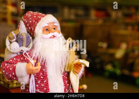 Souvenir doll of santa claus close up. Toy santa claus as a symbol of christmas and new year. Selective focus Stock Photo