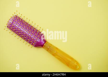 Hair Brush with handle with space copy on Yellow background Stock Photo