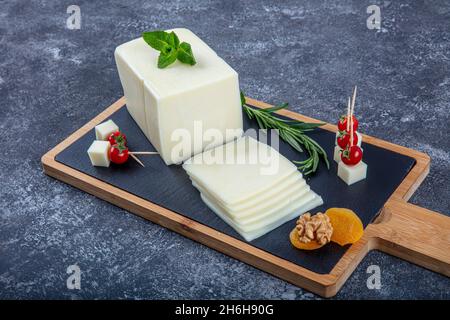 Kashar cheese or kashkaval cheese. Sliced Cheddar Cheese. gourmet cheese. local name taze kasar peyniri Stock Photo