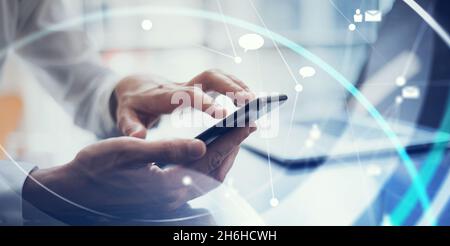 Businessman working remotely. Concept of networking or remote work. Global business network. Close-up of male hands with smartphone Stock Photo