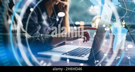 Close-up photo of female hands with laptop. Young woman working remotely at home. Concept of networking or remote work. Global business network. Onlin Stock Photo