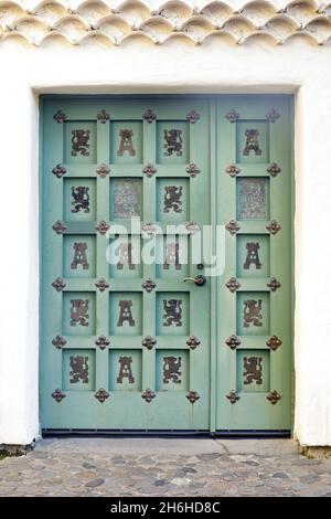 Spanish Colonial Wooden Door with Wrought Iron Decorations. San Francisco Bay Area, California, USA. Stock Photo
