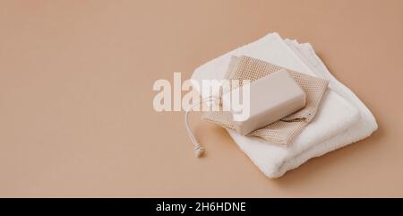 A bar of natural handmade soap lies on a soft white towel. Health beauty natural products concept. Organic natural cosmetics Stock Photo