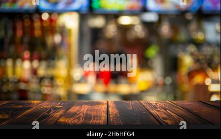 Wooden table rustic bar background. Bar and restaurant blurred background with texture old kitchen table. High quality photo Stock Photo