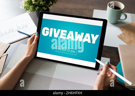 Giveaway, enter to win text on screen. Lottery and prizes. Social media marketing and advertising concept. Stock Photo