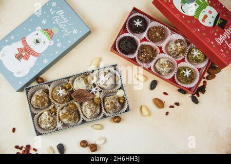Delicious organic homemade portioned raw candies stacked in gift Christmas boxes. Card concept. Top view. Flat lay Stock Photo