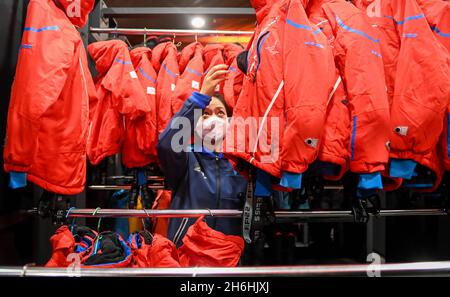 (211116) -- FUSONG, Nov. 16, 2021 (Xinhua) -- A staff member prepares ski suits at Changbaishan Ski Resort in northeast China's Jilin Province, Nov. 15, 2021. Following the recent snowfall and drop in temperature, a new ski season has kicked off in northeast China's Jilin Province. Jilin, with rich ice and snow resources, has long been one of the most popular skiing destinations in the country. Due to the rising skiing boom around the country in recent years, the ski resorts in Jilin have seized the opportunity to improve the infrastructures and services. As the 2022 Beijing Winter Olympics ap Stock Photo