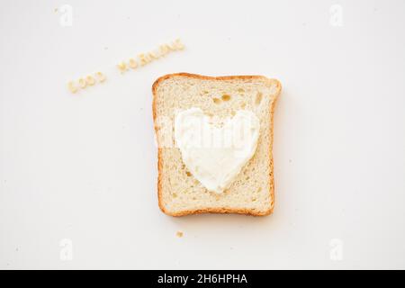 sandwich for breakfast in the form of heart with cheese - good morning inscription Stock Photo