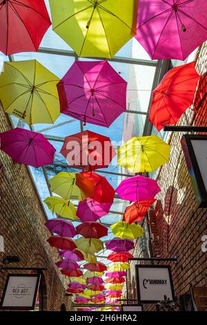 The colourful umbrella alley in Camden stables market, Camden Town, London. Stock Photo