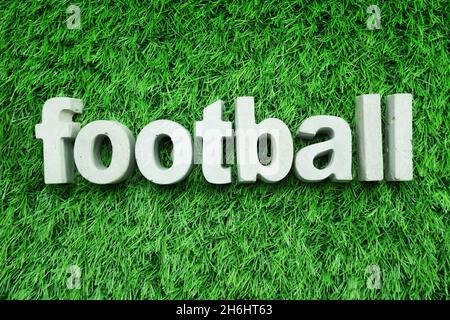 Football made from concrete alphabet top view on green grass Stock Photo